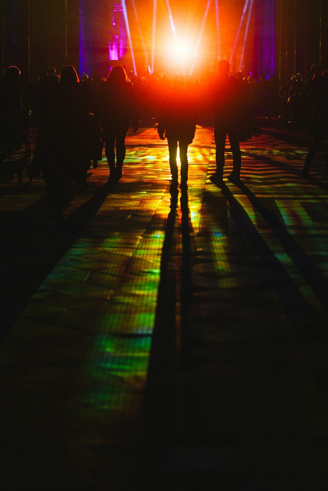 Fashion runway show with models walking under bright stage lights