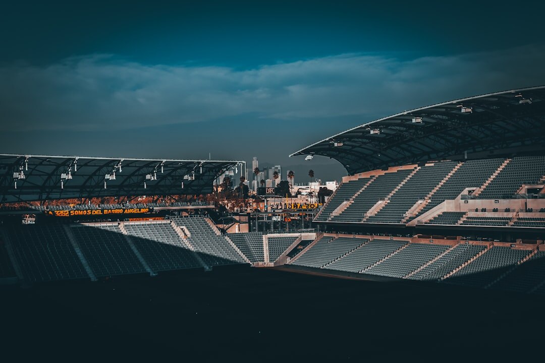 Football stadium at night filled with fans and bright floodlights